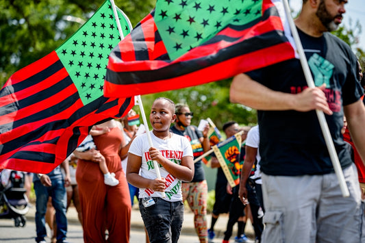 Juneteenth celebration with people holding Pan-African flags.