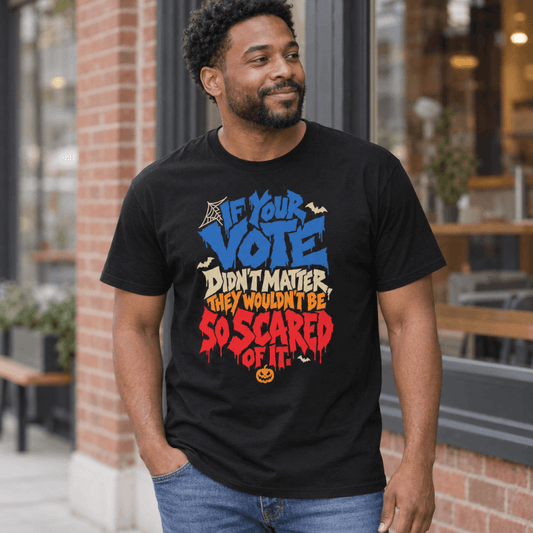 Smiling man outside a brick storefront wearing the black So Scared Of It t-shirt