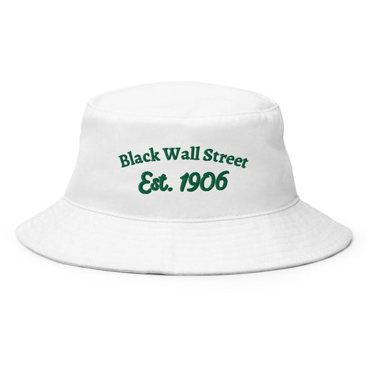 White bucket hat with green embroidered text reading 'Black Wall Street Est. 1906.' Made of 100% cotton, celebrating Black history and culture.