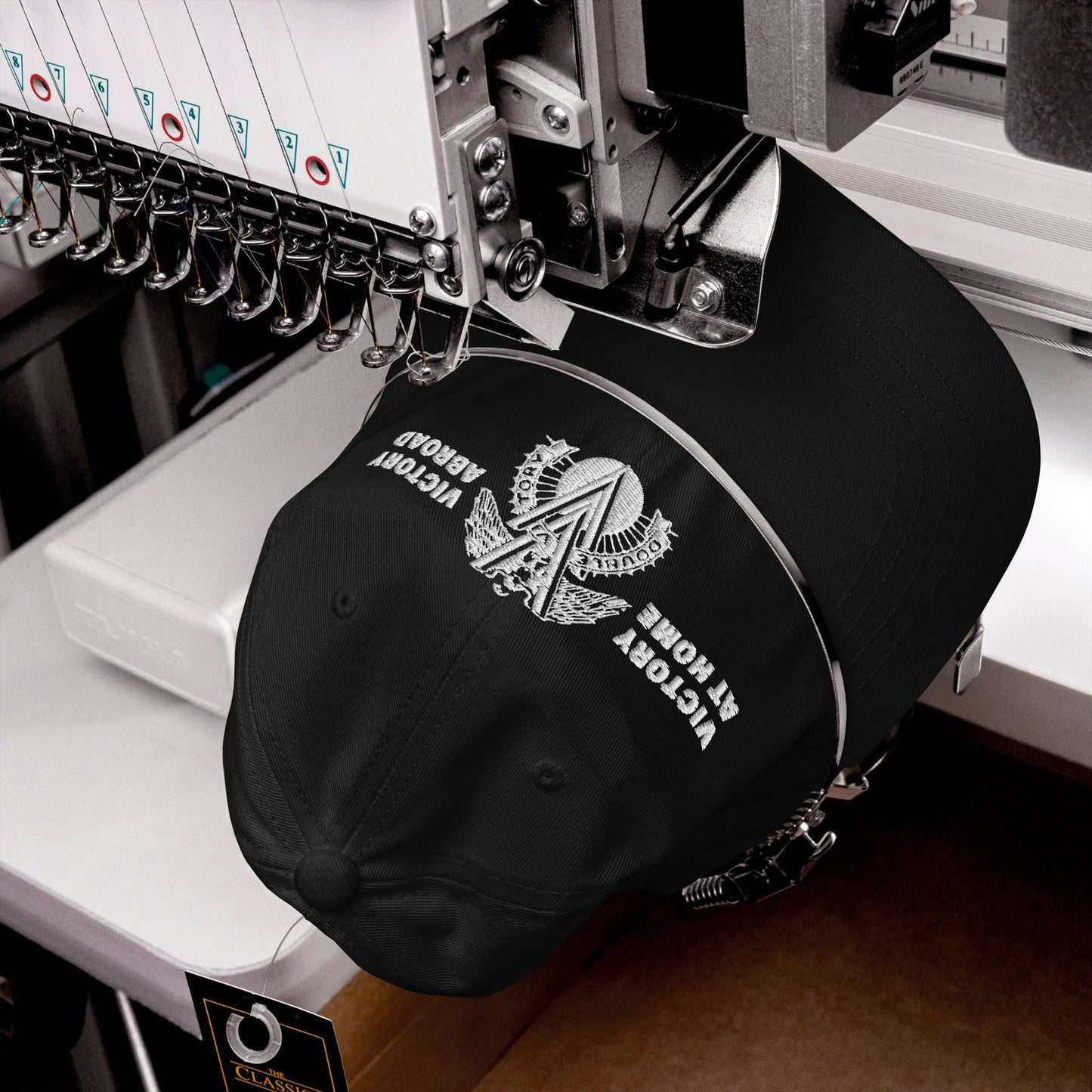 Close-up of the Double V Campaign Victory Home Abroad Baseball Cap being embroidered, highlighting craftsmanship and design precision.