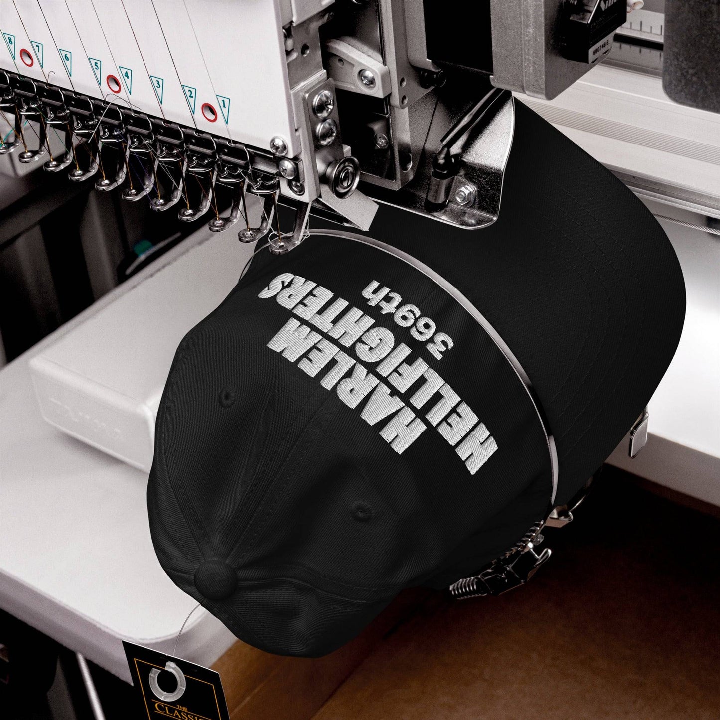 Close-up of Harlem Hellfighters 369th cap being embroidered in a machine. High-quality stitching process for durable and bold statement headwear.