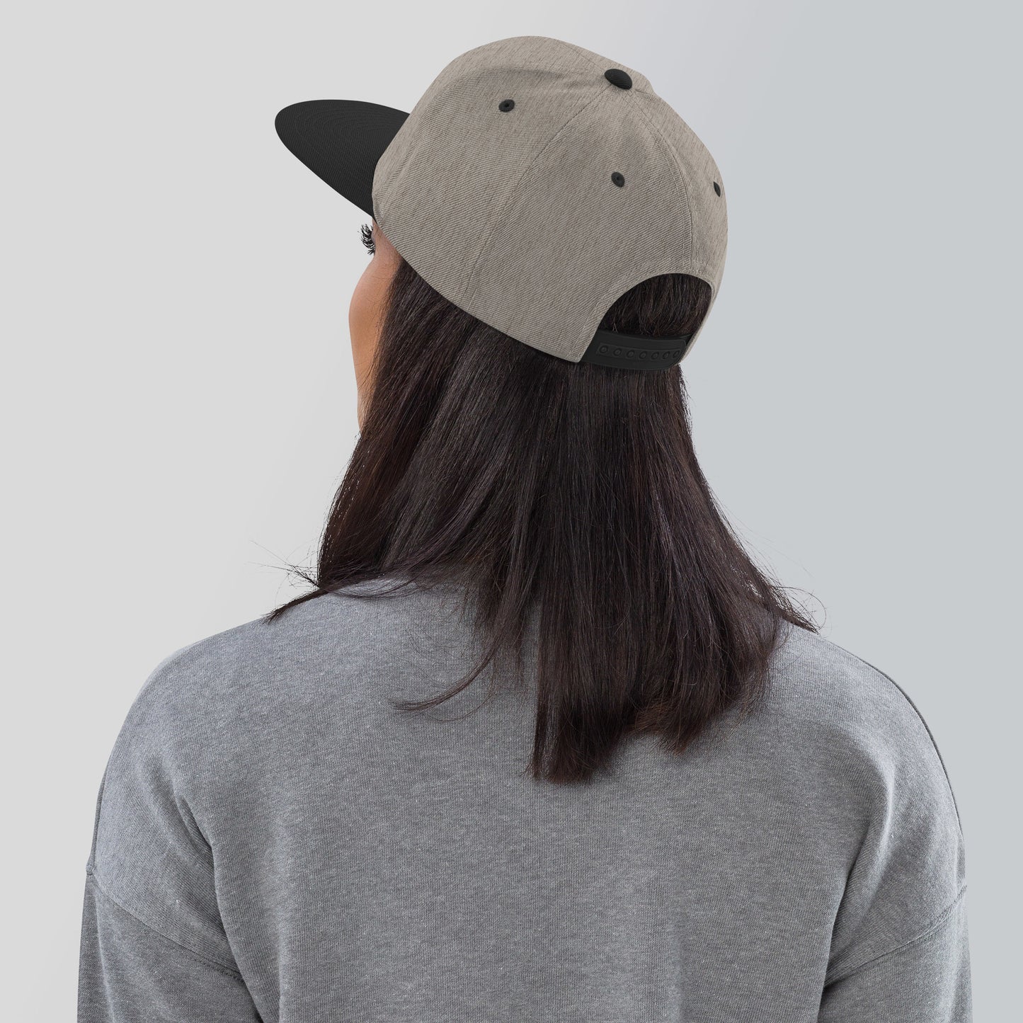 a person wearing a hat with a black spot on it