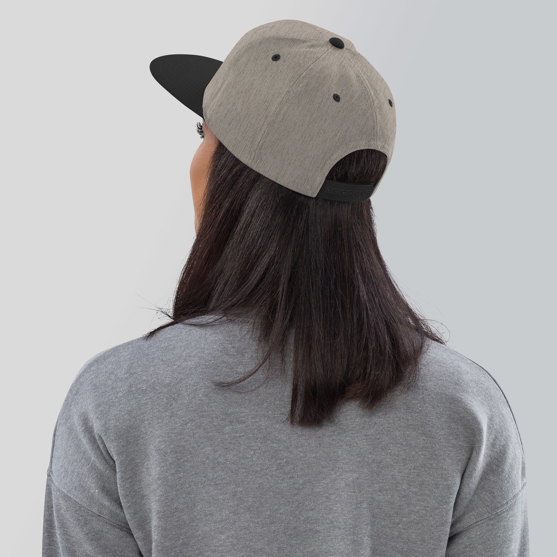 a person wearing a hat with a black spot on it