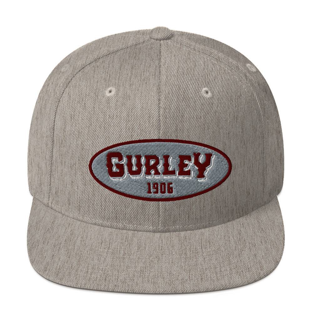 a grey hat with the word gurley on it