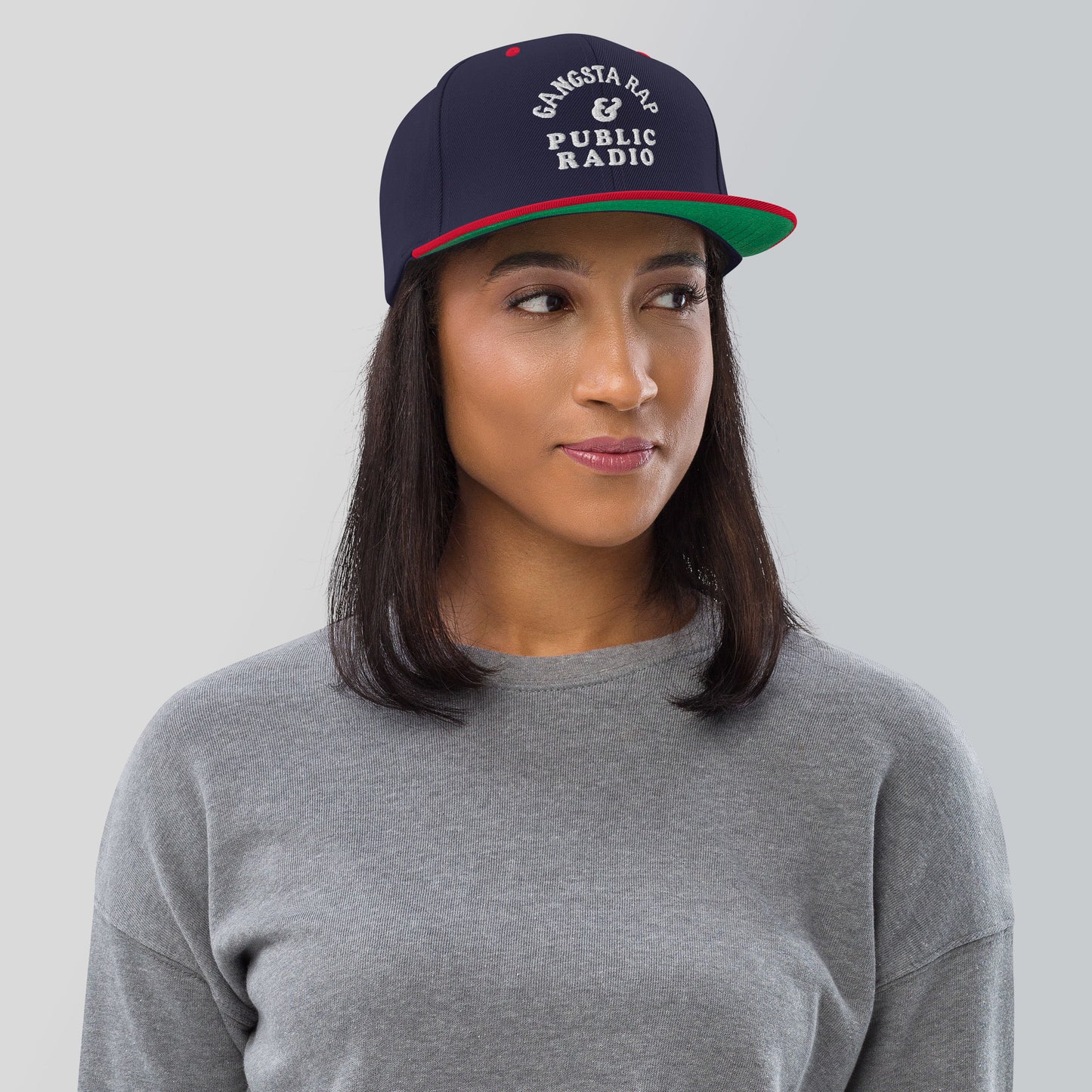 a woman wearing a grey shirt and a hat