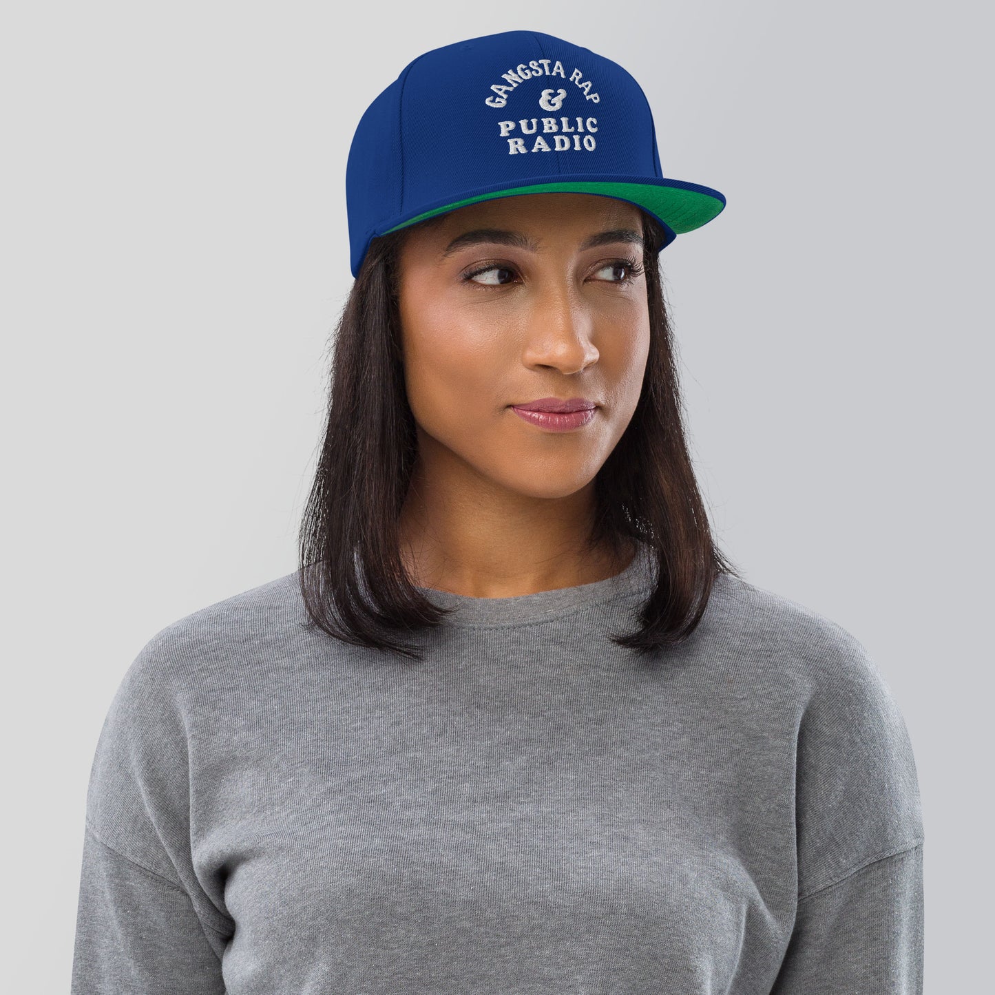 a woman wearing a blue and green hat