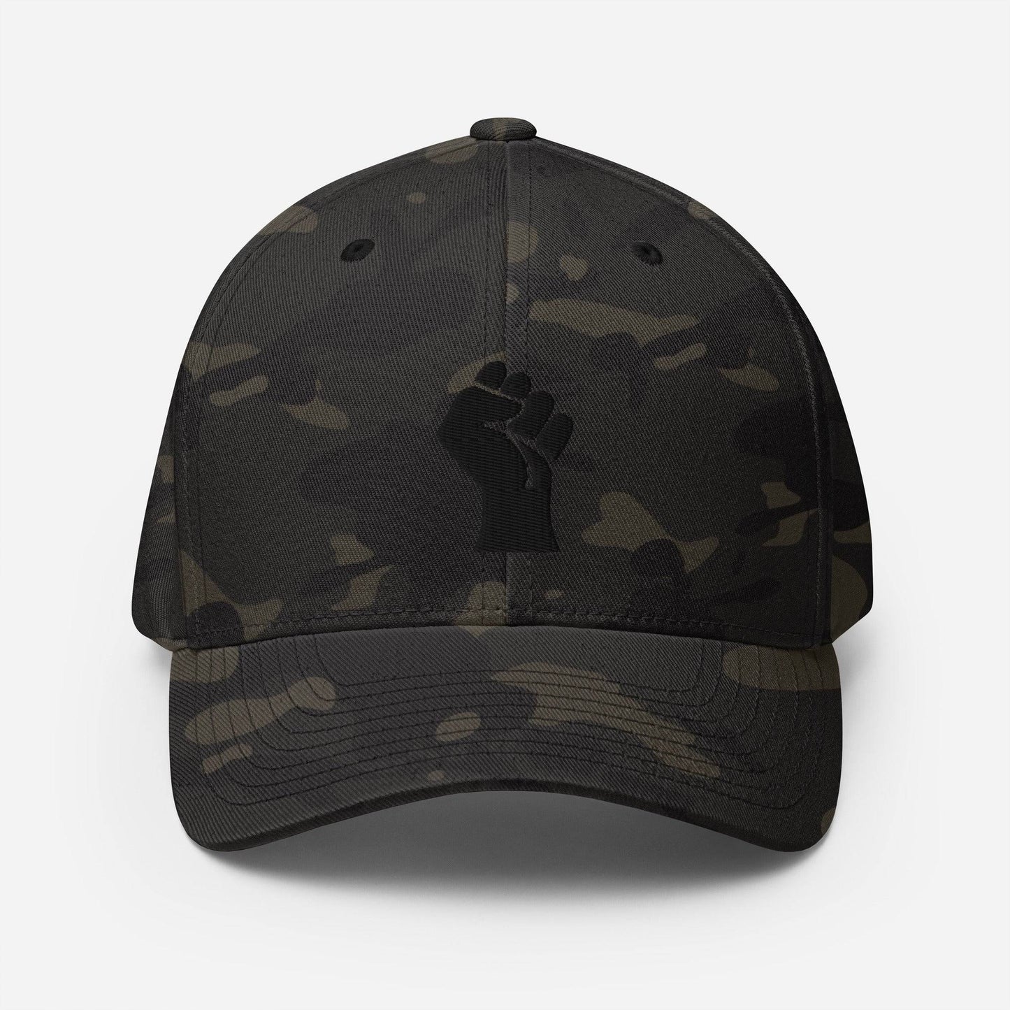 Black camo Flexfit structured cap with tonal black embroidered power fist, blending urban style and cultural identity by TheBlackest Co.