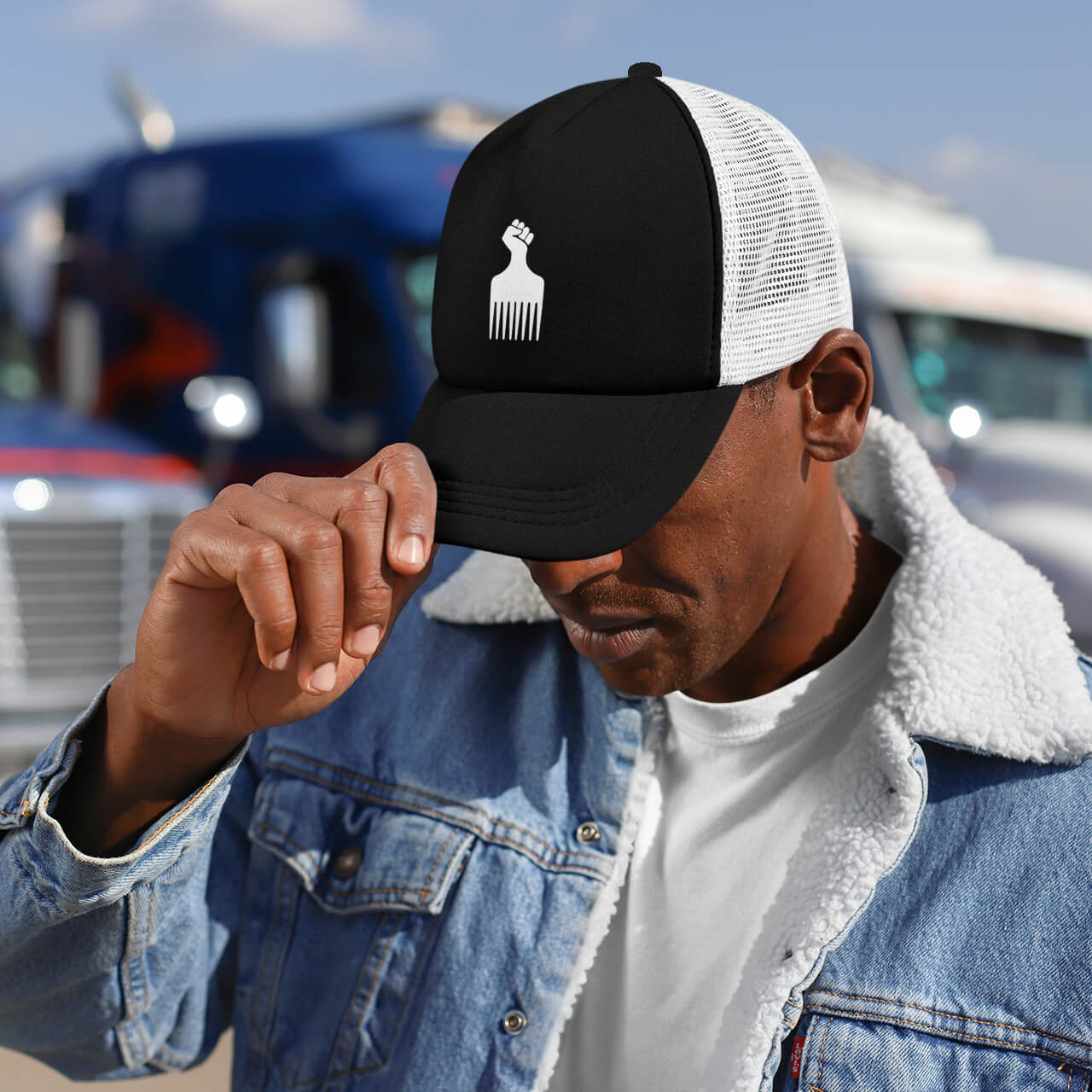Man wearing Black Power Fist Retro Trucker Cap outdoors