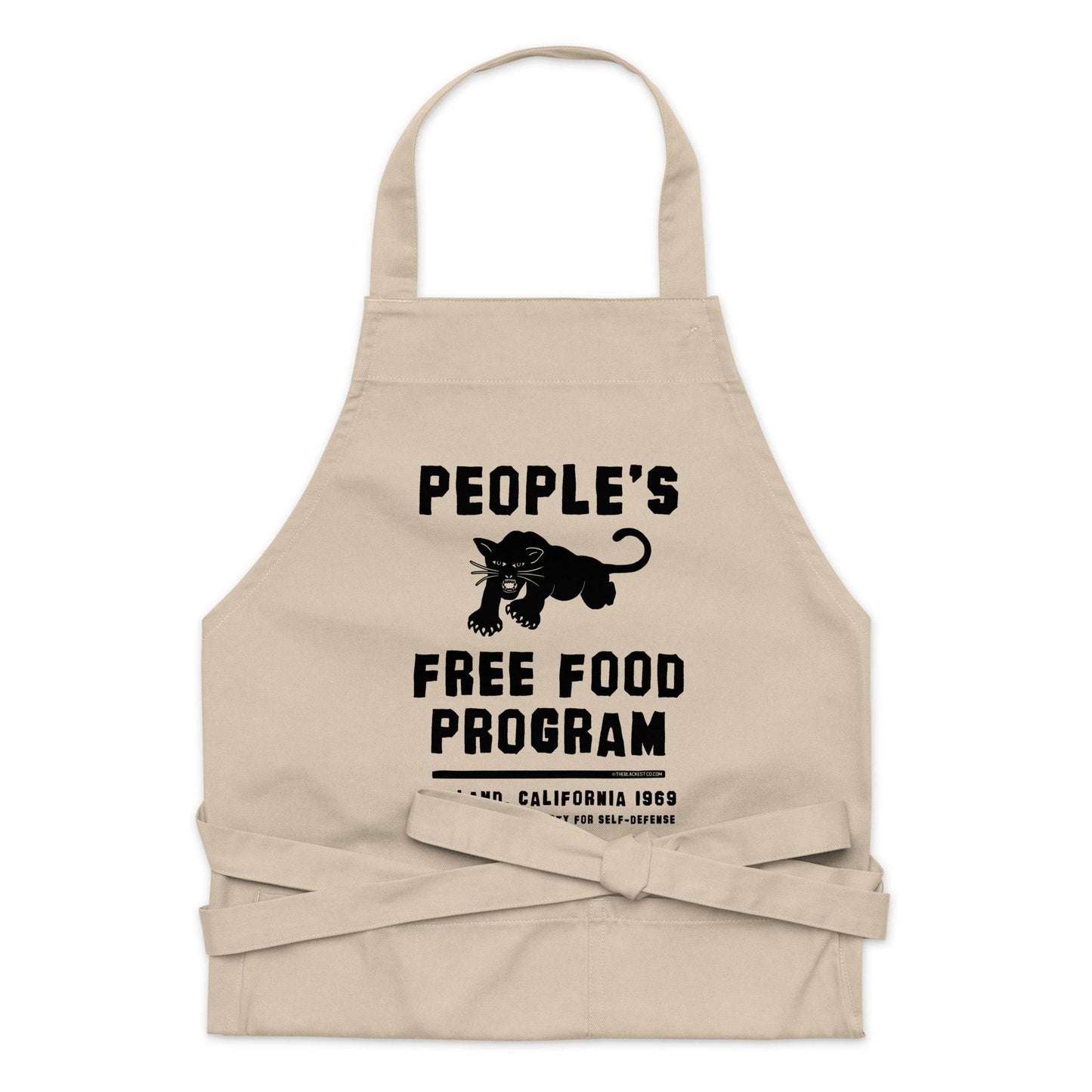 Flat lay of BPP People's Free Food Program Organic Cotton Apron in beige with front pocket and waist ties, ideal for kitchen or garden use.