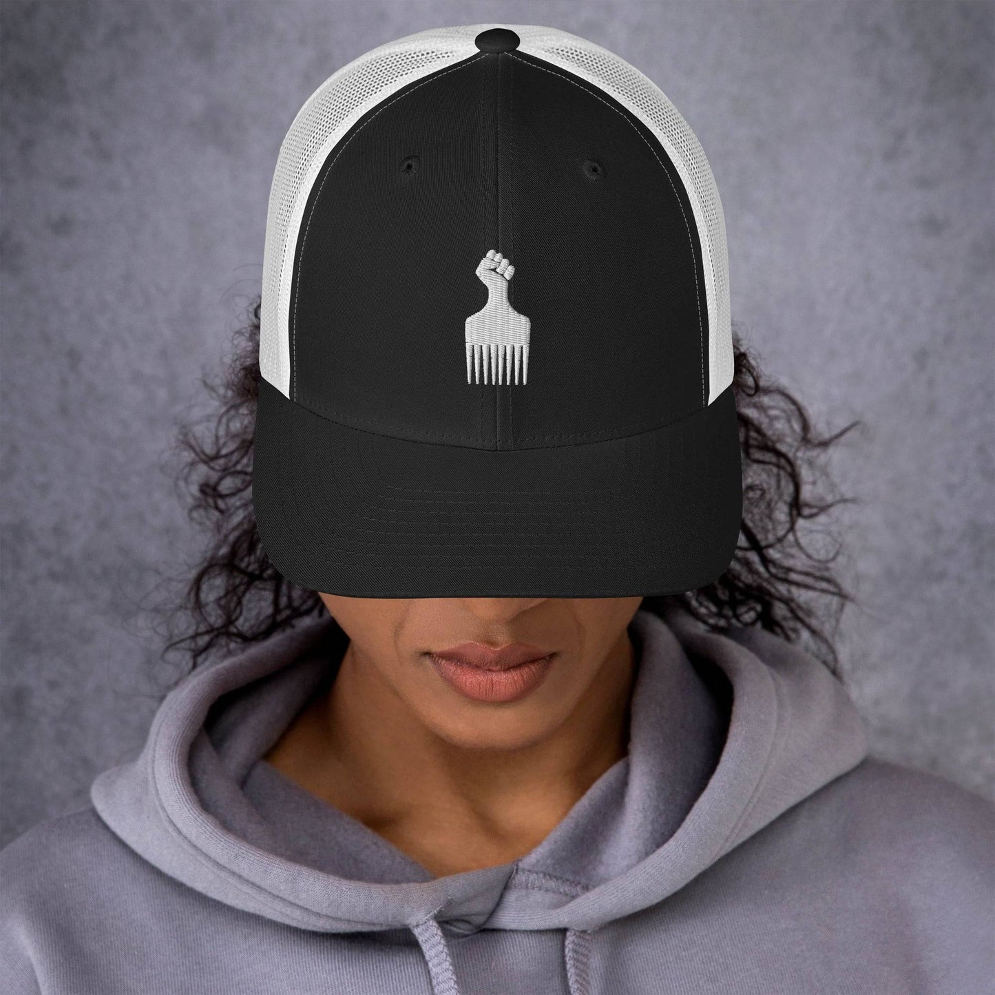 Woman wearing Black Power Fist Retro Trucker Cap front view