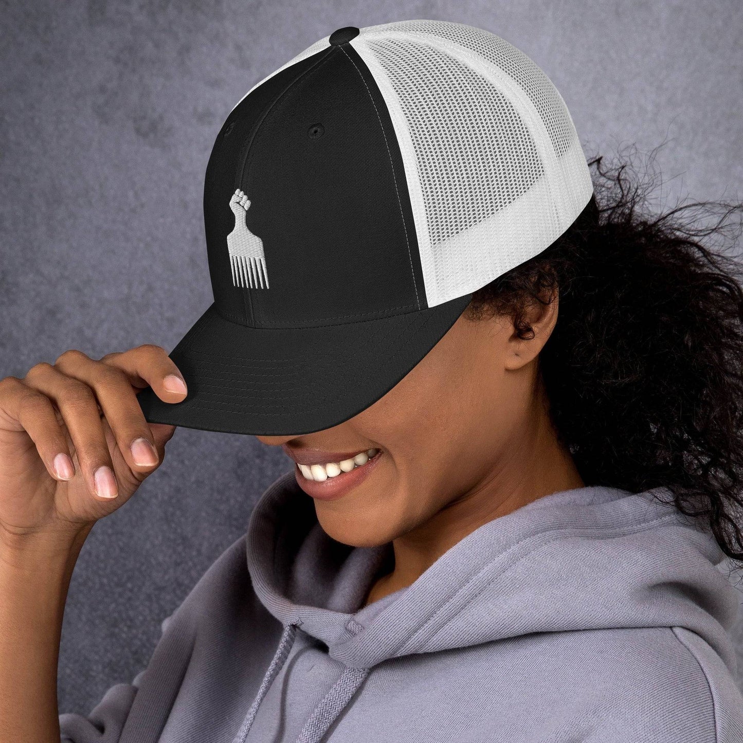 Woman smiling in Black Power Fist Retro Trucker Cap