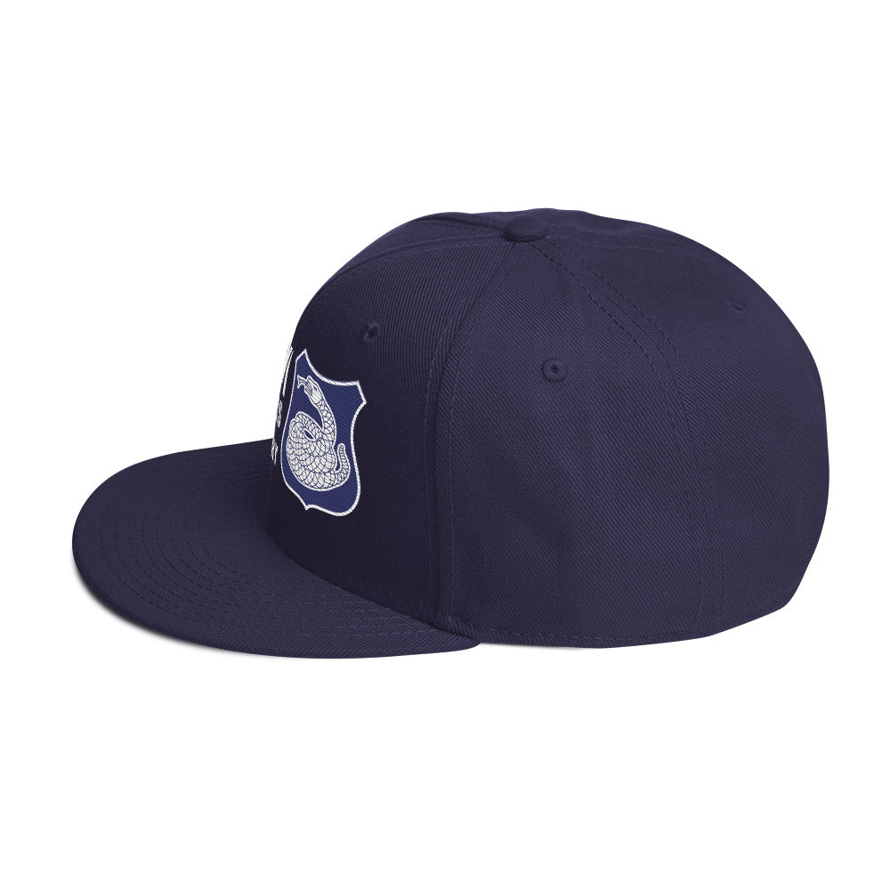a blue hat with a white and purple rattlesnake crest on it with text that reads harlem hellfighters 369th infantry regiment