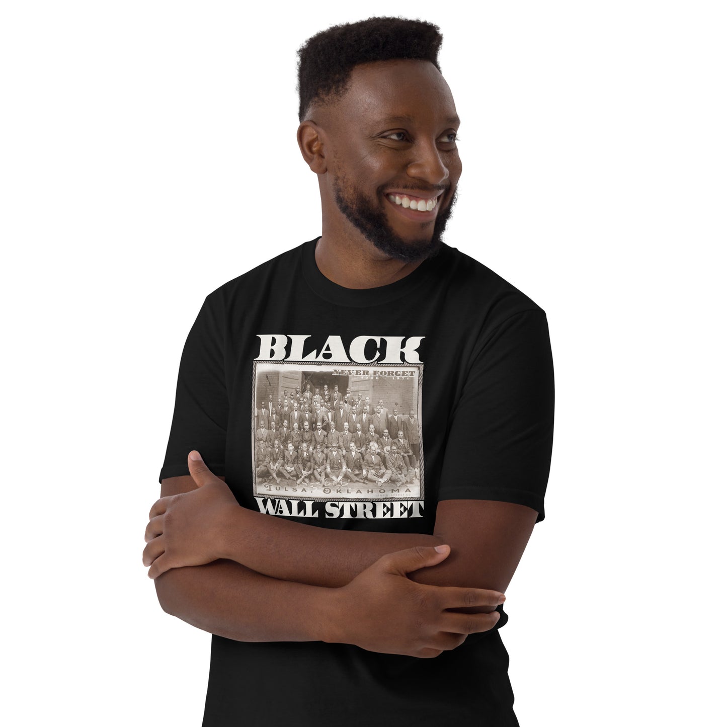 a man wearing a black t - shirt with a black wall street picture on it