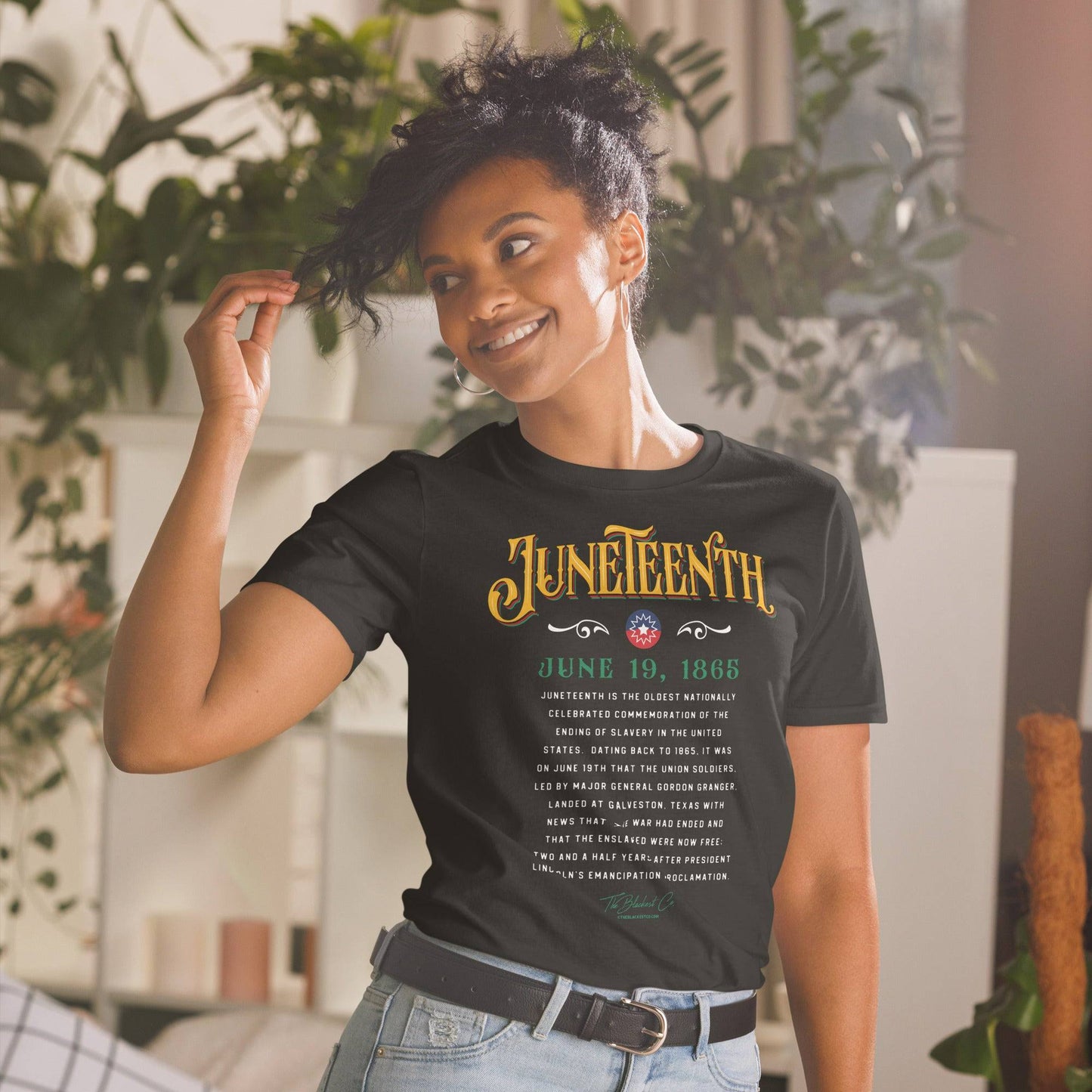 a woman wearing a black shirt with Juneteenth and the history of it written on it