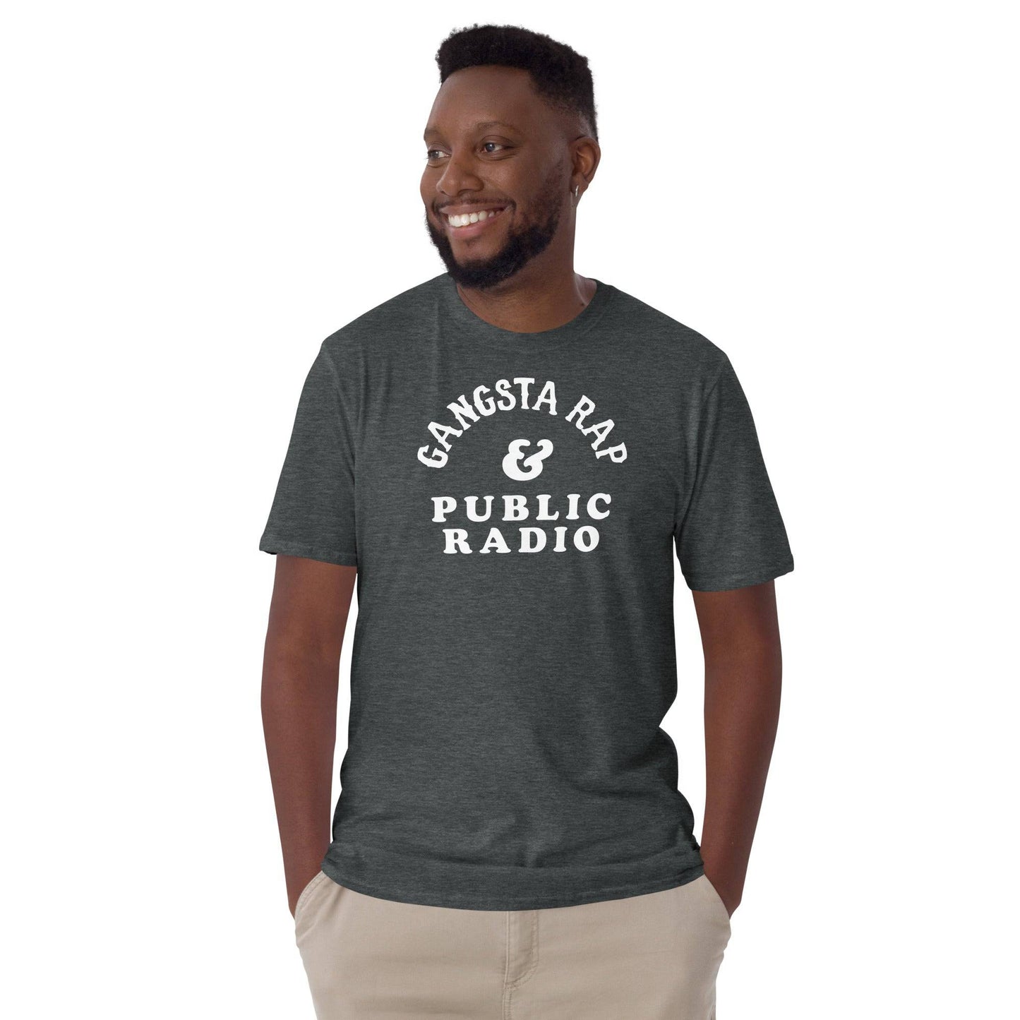 Man modeling Gangsta Rap & Public Radio Softstyle Unisex T-Shirt in dark heather, casual fit for music and culture lovers.