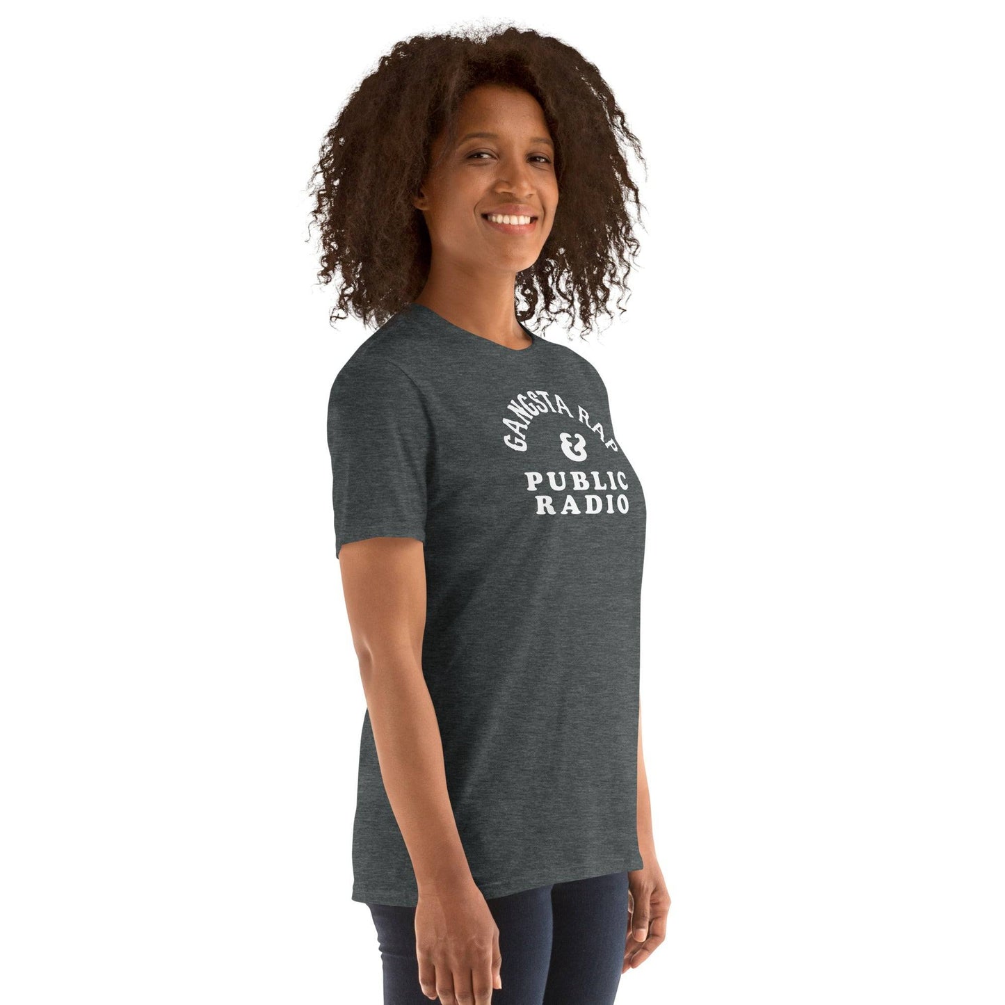 Side view of woman in Gangsta Rap & Public Radio Softstyle Unisex T-Shirt, showcasing relaxed fit and cultural statement.