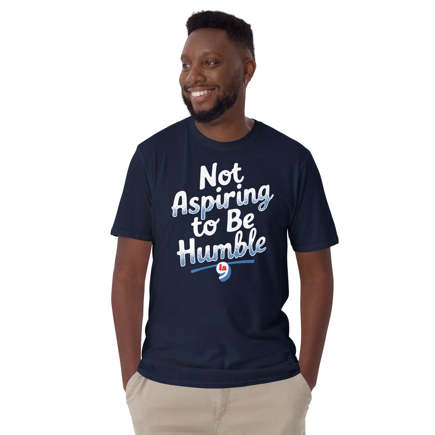 Man smiling in navy 'Not Aspiring to Be Humble' t-shirt