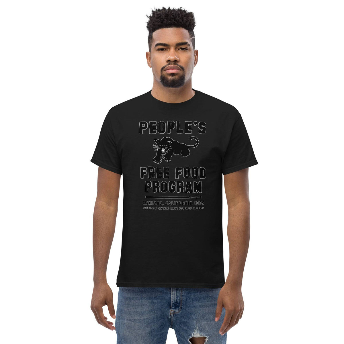 Front view of model in Black On Black BPP Free Food Program Staple T-Shirt, showcasing bold panther design and tribute to 1969 Oakland community program.