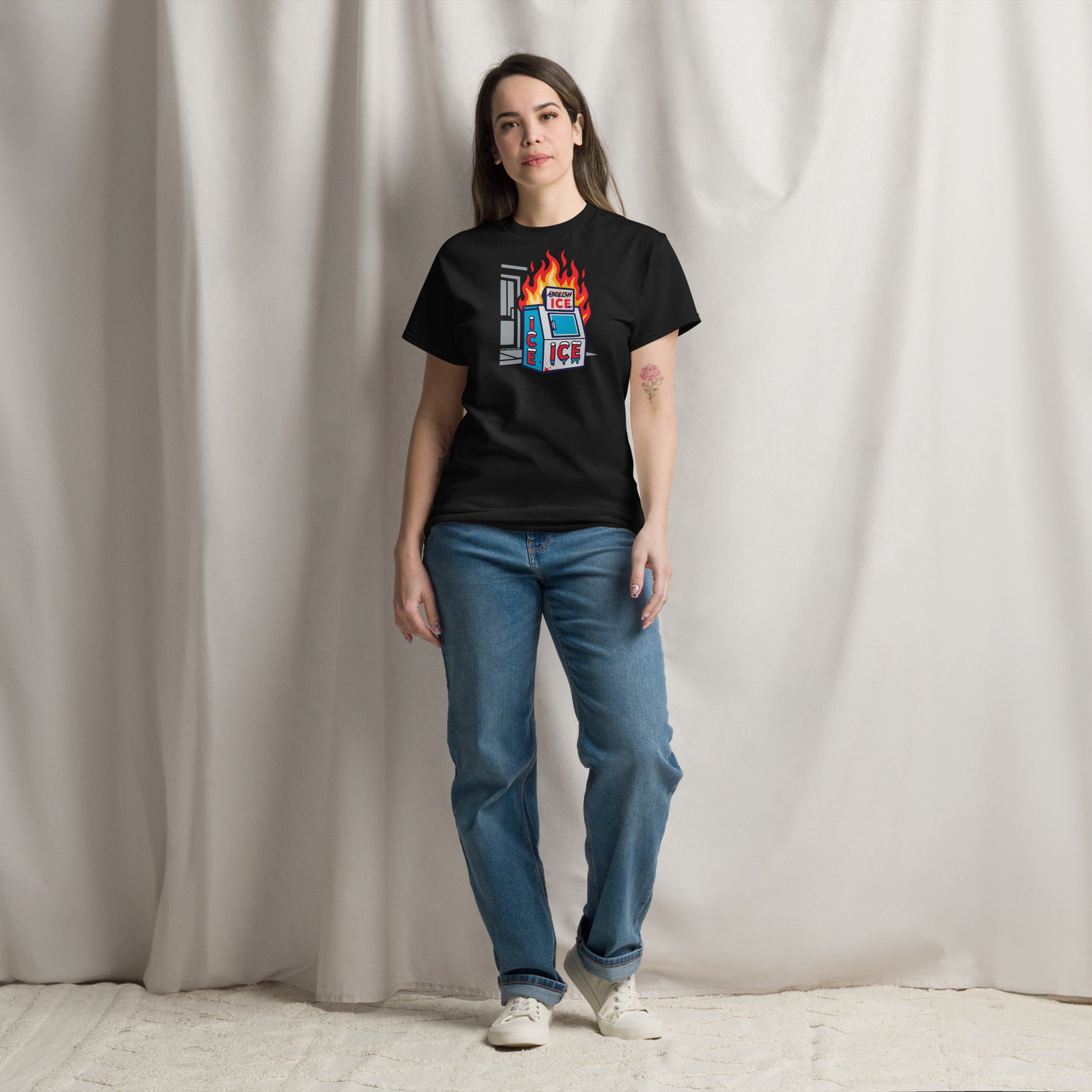 Model wearing black Abolish ICE Statement Staple Unisex T-Shirt by TheBlackest Co., styled with jeans for a bold protest fashion look.