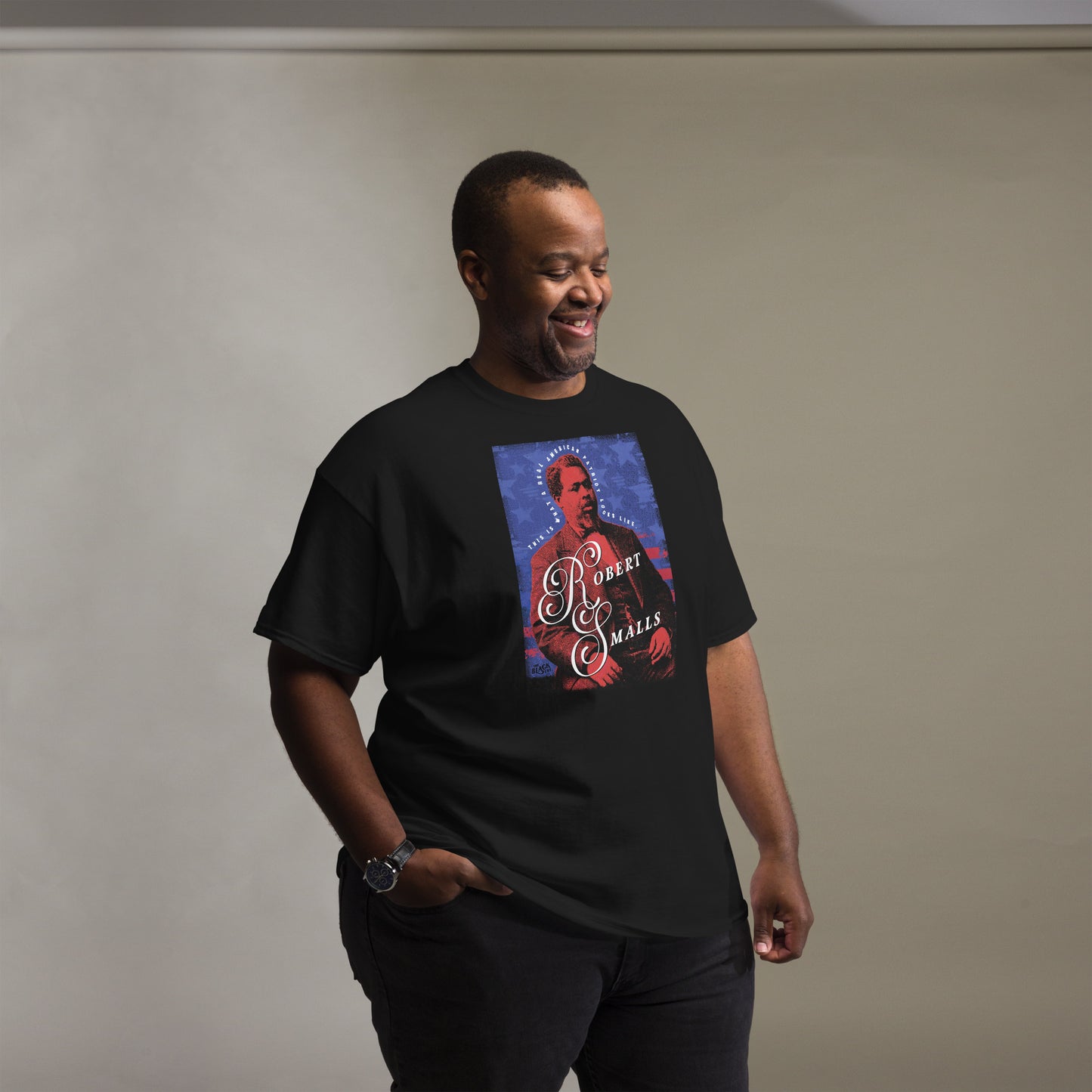 Smiling man wearing Robert Smalls Real American Patriot Unisex T-shirt by TheBlackest Co., celebrating Black history and legacy.