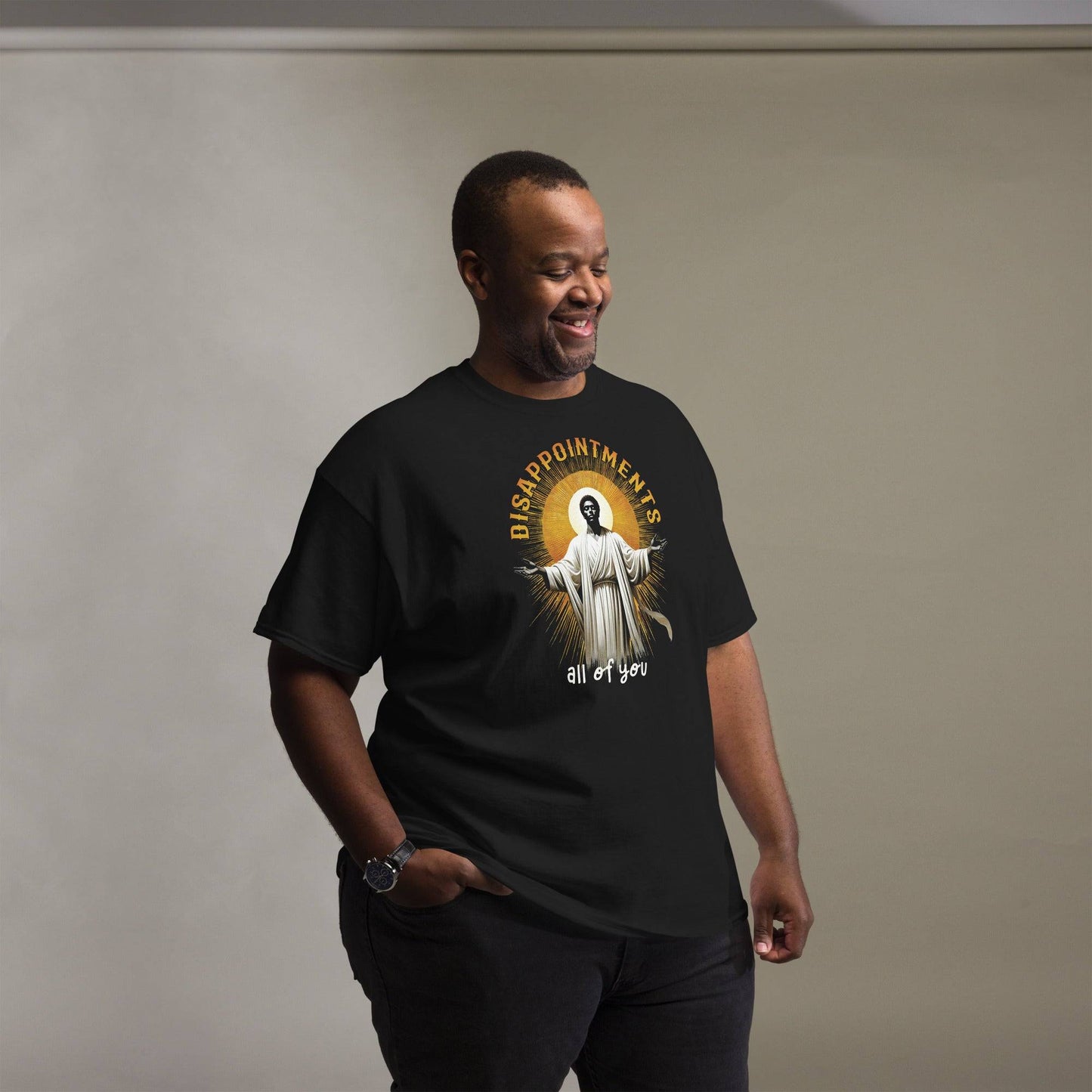 Man wearing Disappointments All Of You Black Jesus T-Shirt in black, showcasing bold cultural graphic and relaxed fit for streetwear style.