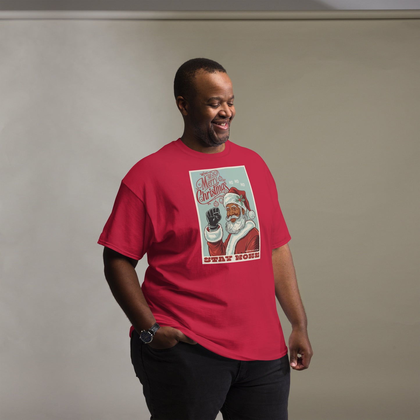 Plus-size model in red Black Santa Stay Woke Unisex Staple T-Shirt, showcasing inclusive sizing and festive cultural design.