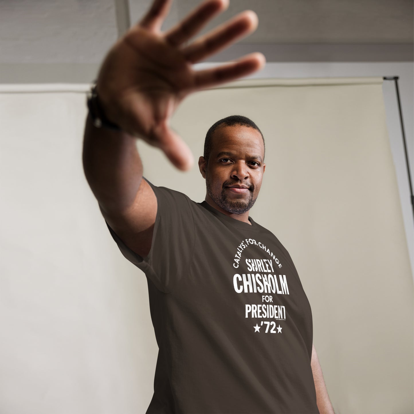 Man posing in brown Shirley Chisholm 72 T-Shirt