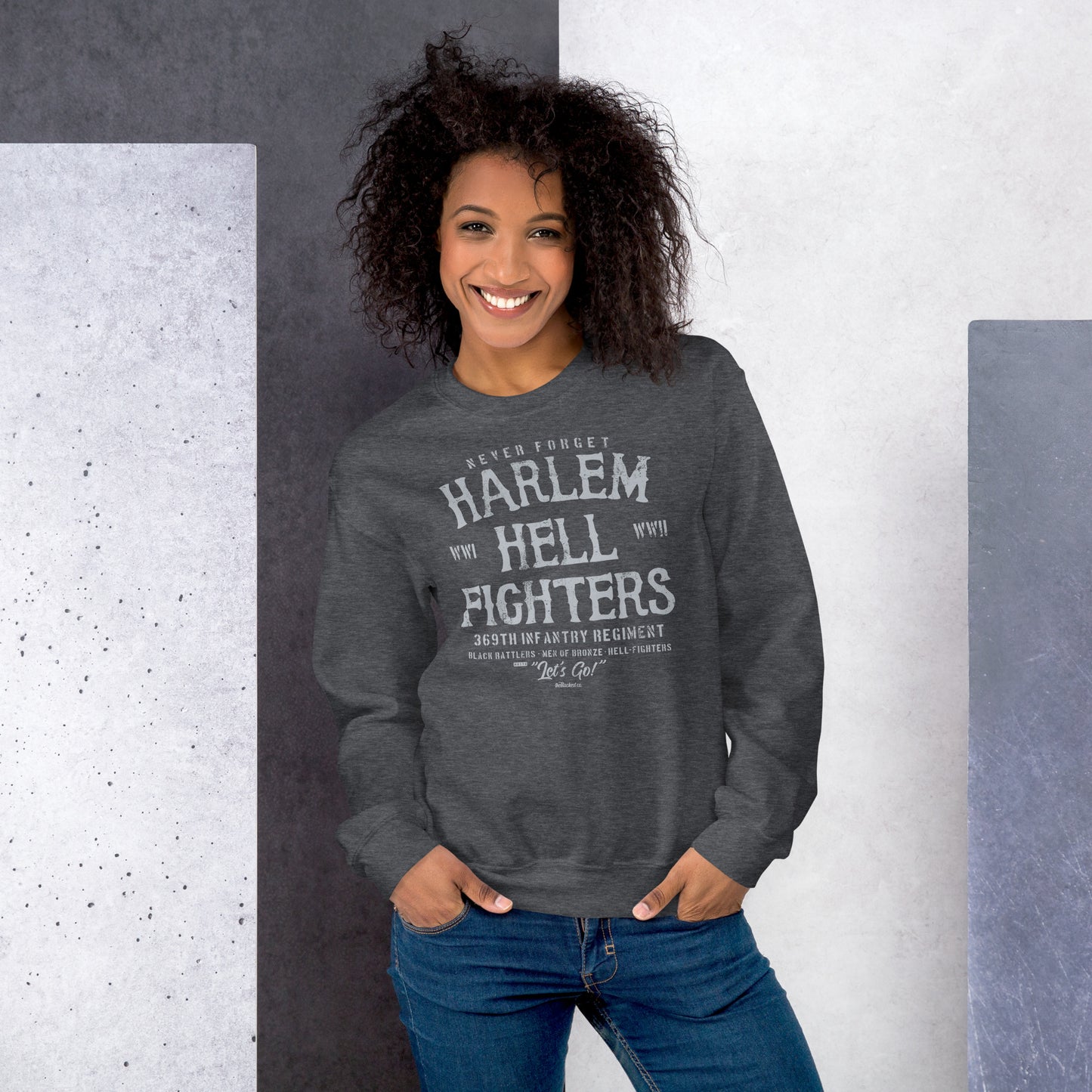 woman wearing dark grey sweatshirt with white text reading harlem hellfighters