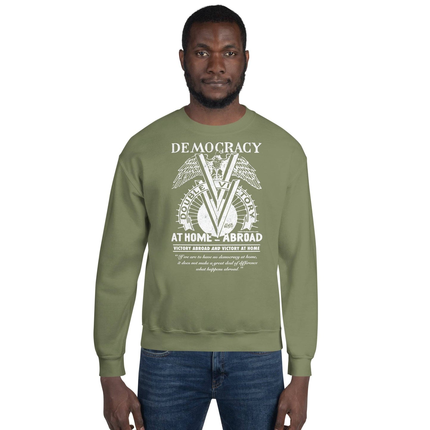Man wearing olive green Double V Campaign WWII Black Soldiers Sweatshirt featuring vintage-style graphic celebrating Black military history.