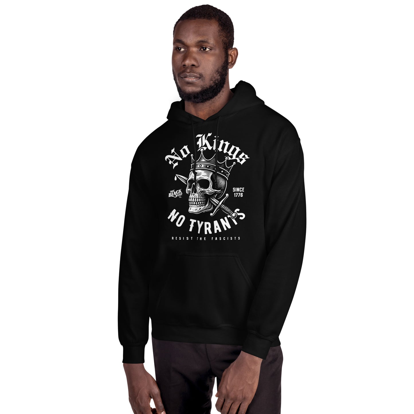 Side view of man in No Kings No Tyrants Skull Protest Hoodie by TheBlackest Co., highlighting bold resistance-themed streetwear graphic.