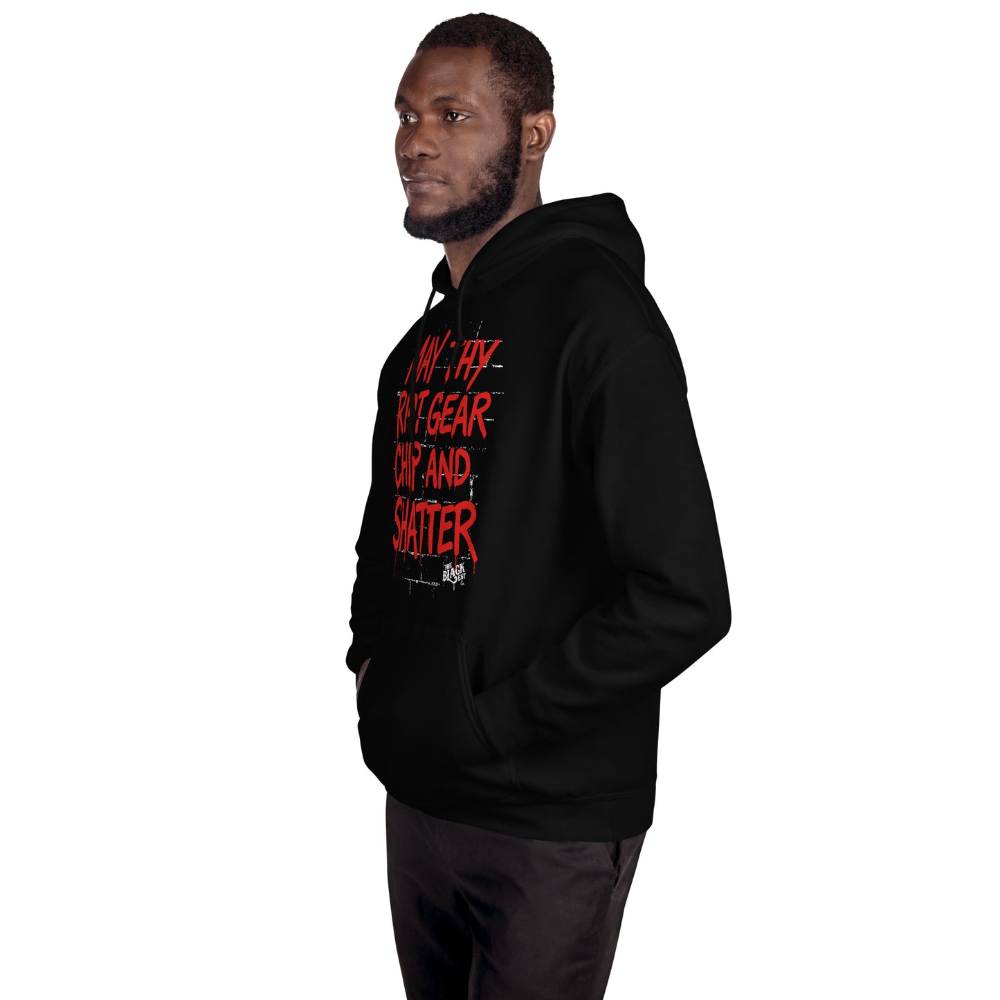 Side view of man wearing black May Thy Riot Gear Chip And Shatter Unisex Hoodie by TheBlackest Co., featuring red protest message for bold streetwear.