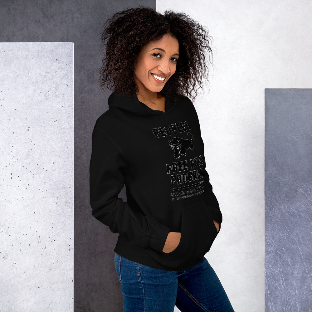 Smiling woman in Black On Black BPP Free Food Program Staple Hoodie, styled casually with jeans, highlighting comfort and cultural pride.