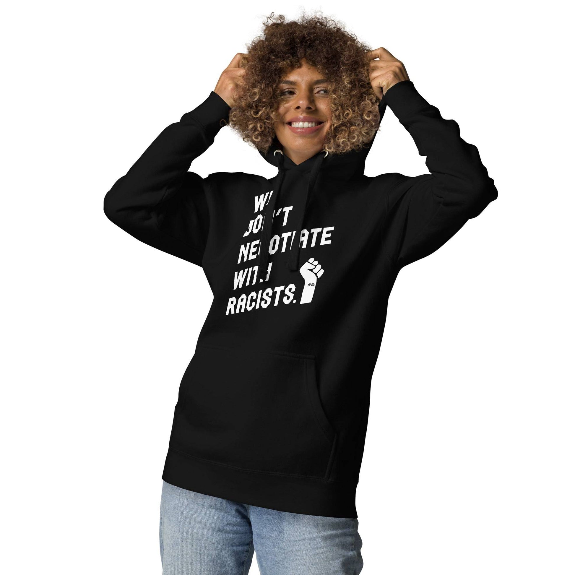 Woman in black hoodie with 'We Don't Negotiate With Racists' text