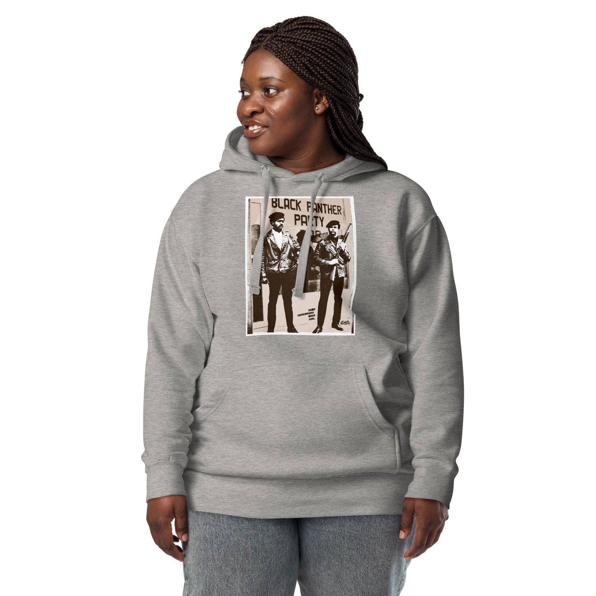 a woman wearing a grey hoodie with a picture of Black panthers Bobby Seale and Huey Newton on it