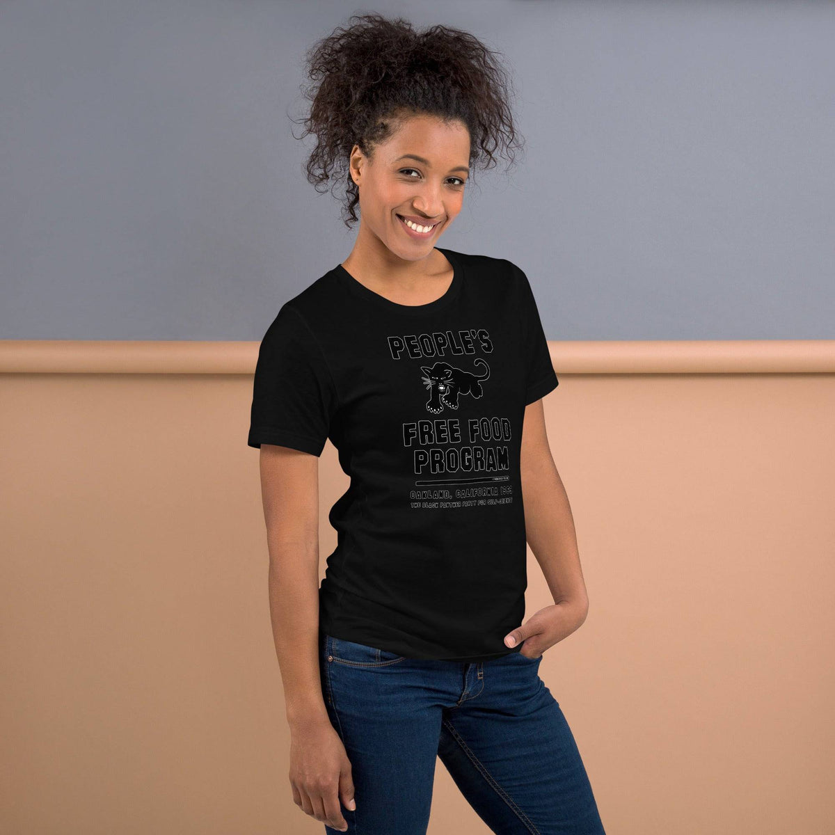 Black On Black BPP Free Food Program Fashion Unisex T-shirt modeled by woman in jeans, highlighting streetwear style and activist message.