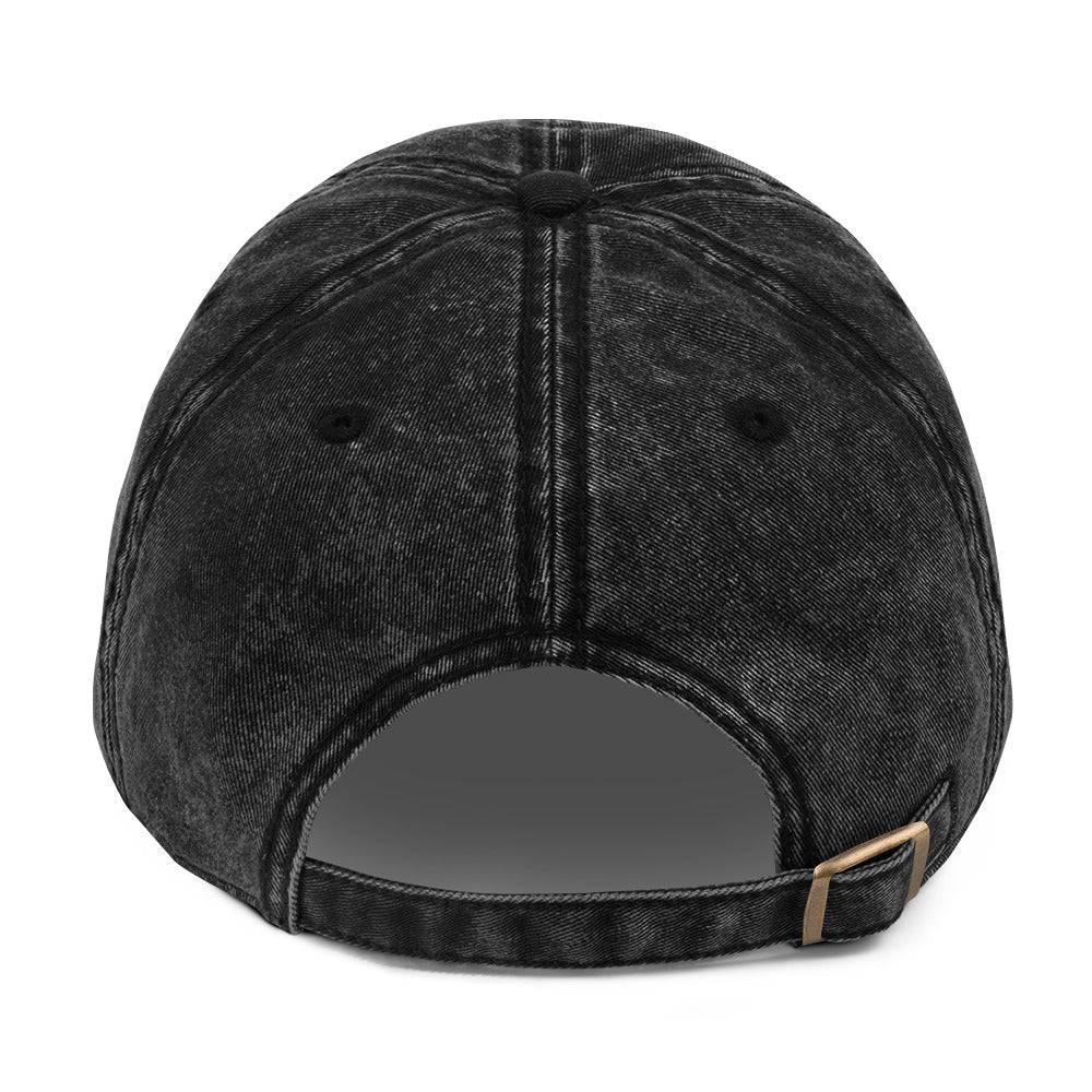 a black baseball cap with a metal bar on the front