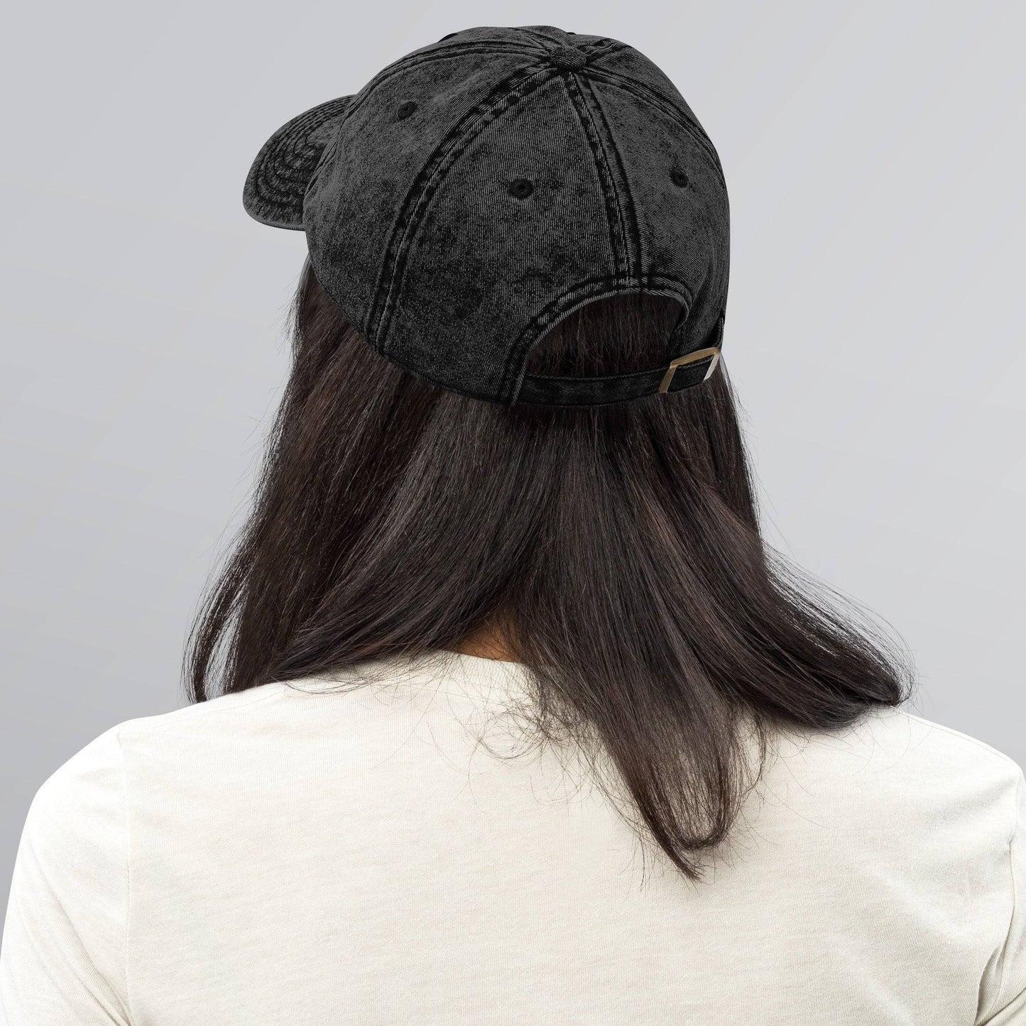a woman with long hair wearing a black hat