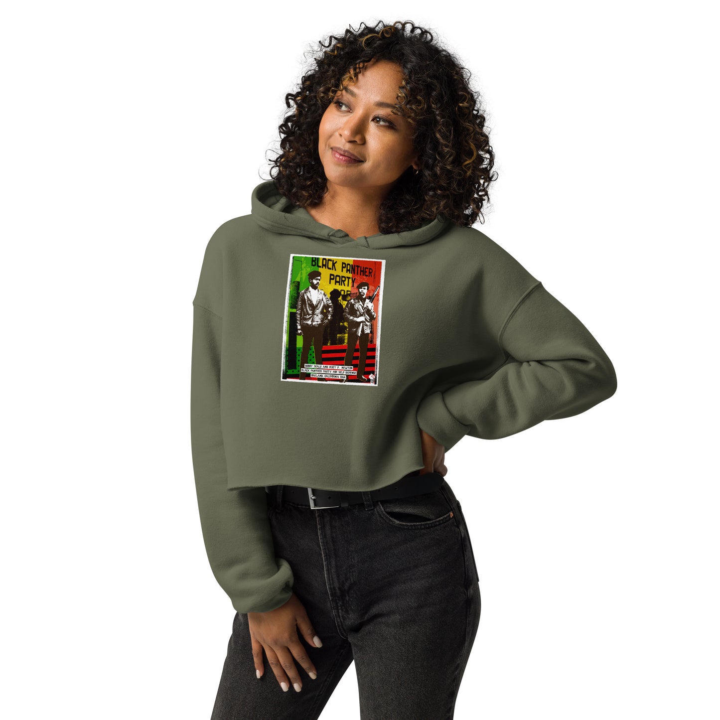 Model wearing The Black Panther Party BPP Storefront Crop Hoodie in olive green, styled with black jeans for a bold cultural fashion statement.