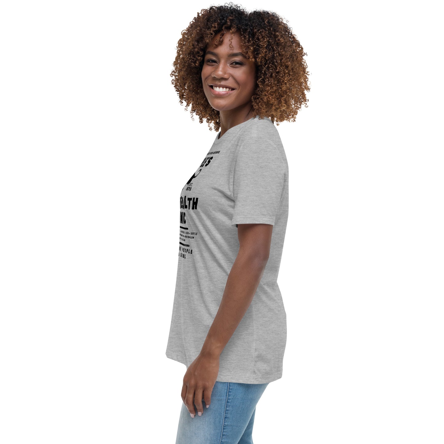 a woman with curly hair wearing a grey shirt