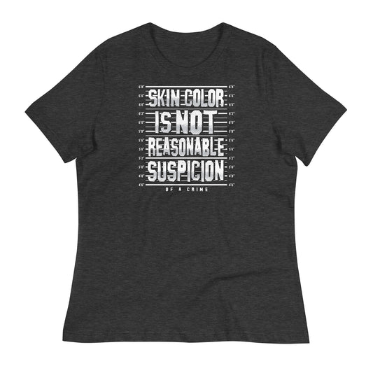 Charcoal black women's relaxed t-shirt with bold white 'Skin Color Is Not Reasonable Suspicion' graphic. Statement tee for social justice support.