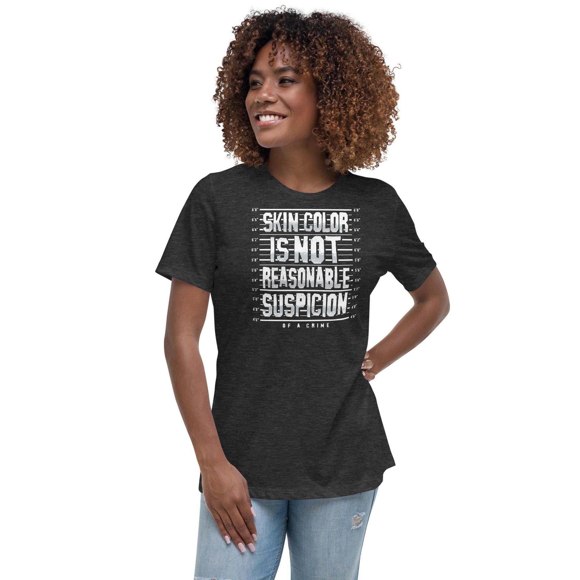 Front view of woman in relaxed-fit activist t-shirt reading 'Skin Color Is Not Reasonable Suspicion.' Empowering apparel for equality and justice.