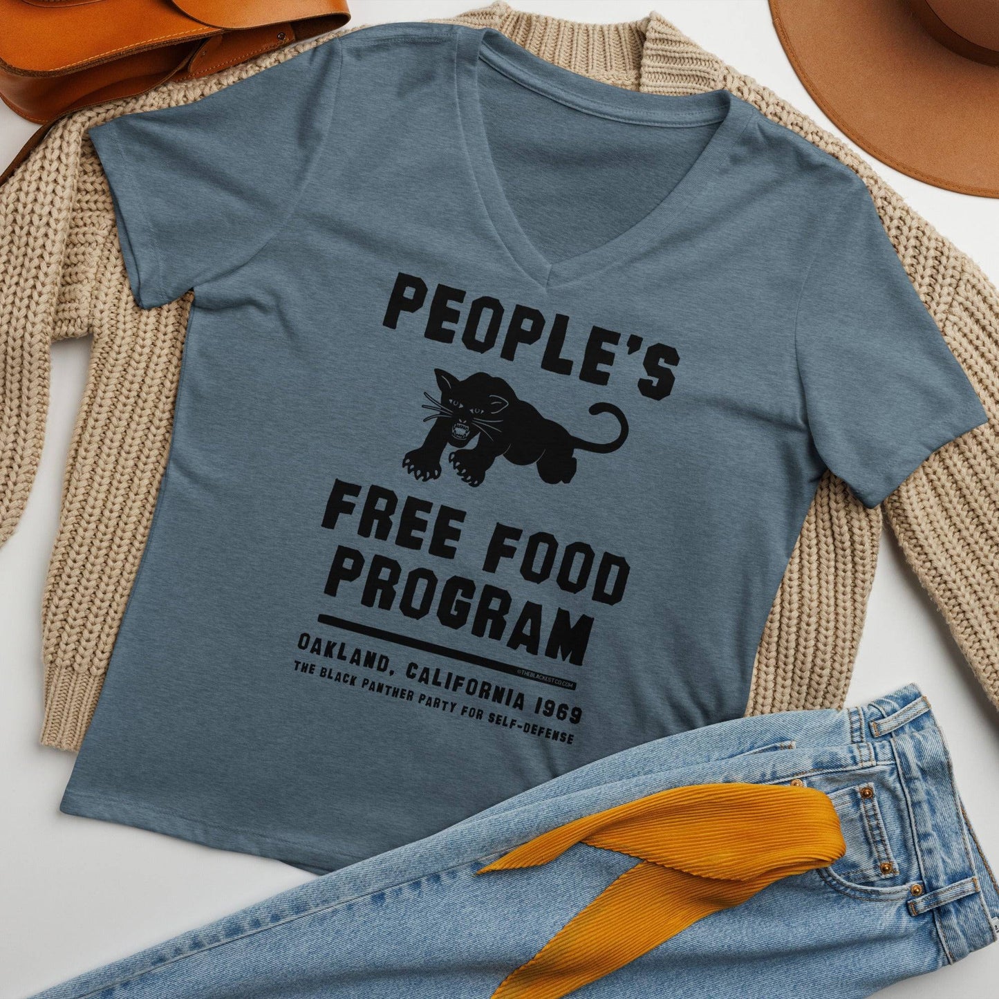 Flat lay of Black Panthers People's Free Food Program Women's V-neck Tee styled with cozy fall accessories, ideal for casual wear.