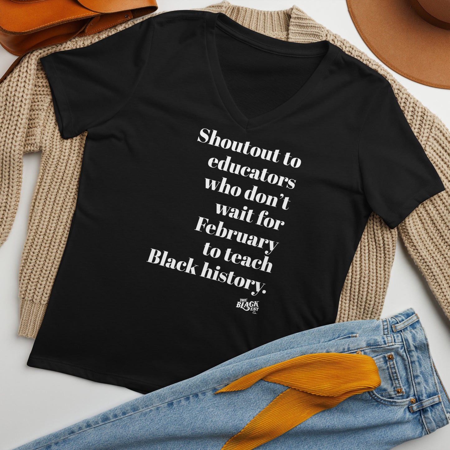 Flat lay of Shoutout To Educators Teaching Black History Womens V-neck T-shirt styled with jeans and sweater, perfect for casual cultural pride.