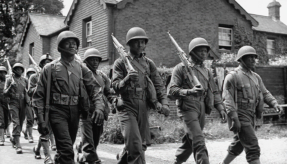 vintage photo of african american soldiers marching in england in WWII