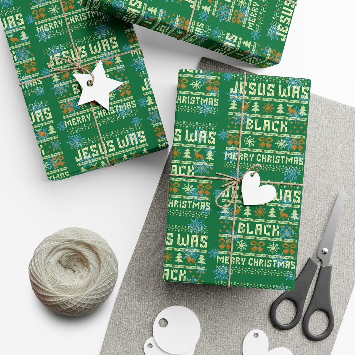 Jesus Was Black Merry Christmas green wrapping paper used on boxed gifts with tags and twine, ideal for bold holiday gift presentation.