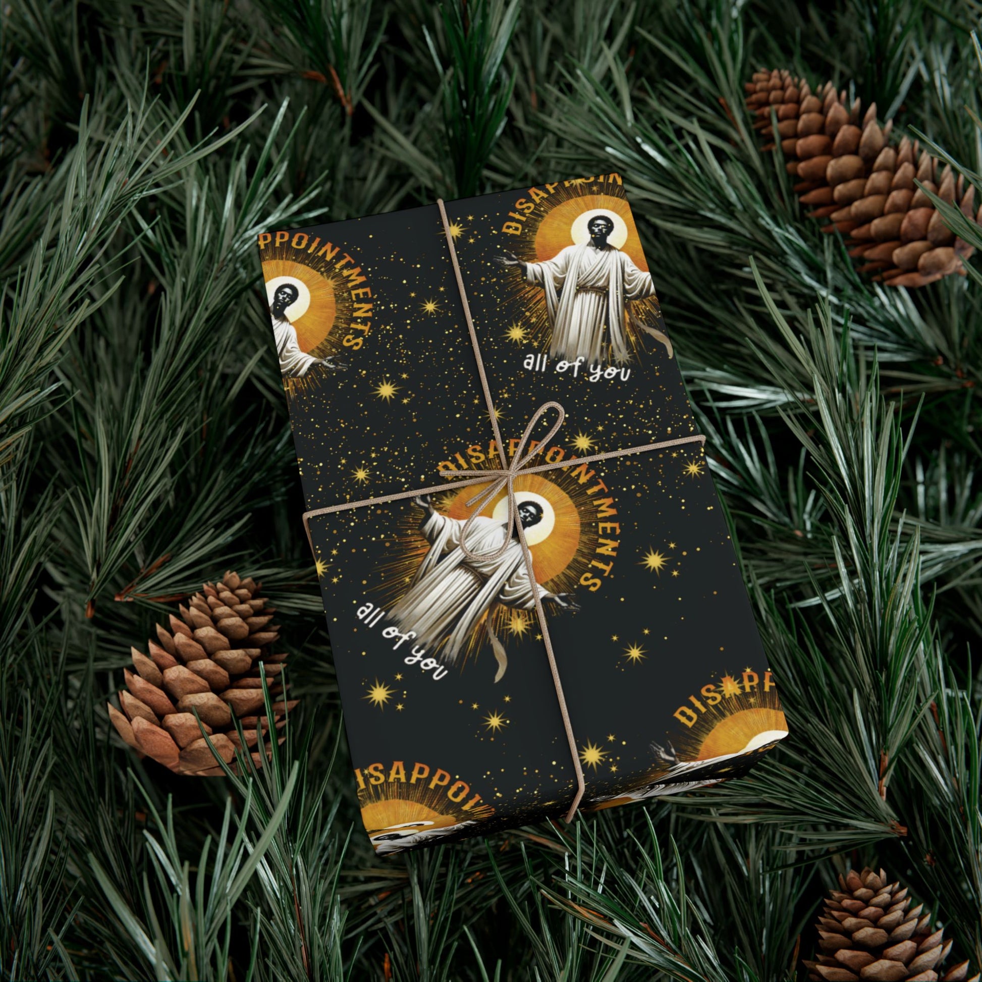 Gift wrapped in Black Jesus Disappointments All Of You Christmas Gift Wrap on pine branches, combining humor and festive style for holiday gifting.