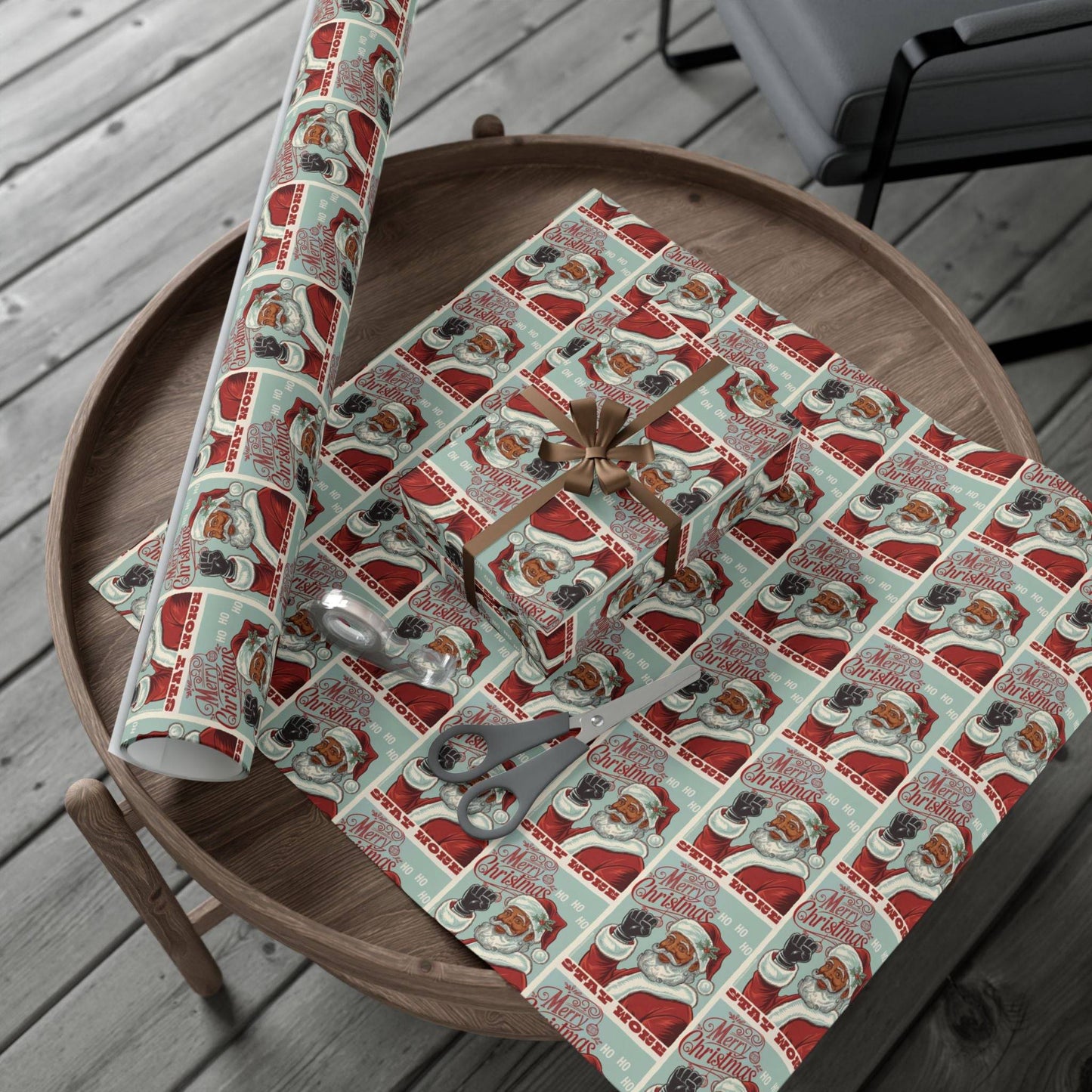Rolled and wrapped Black Santa Stay Woke Christmas Gift Wrapping Paper on a wooden table, perfect for holiday gift packaging with a bold, Afrocentric theme.