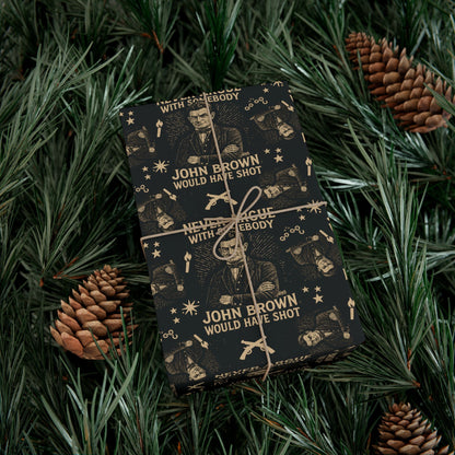 Wrapped gift in John Brown History Christmas Paper nestled in pine branches, featuring abolitionist imagery and strong holiday message.