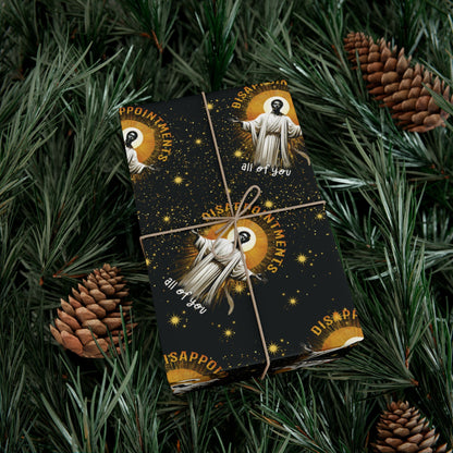 Wrapped gift in Black Jesus Disappointments All Of You Christmas Gift Wrap placed on pine branches, perfect for festive and eco-friendly presentation.