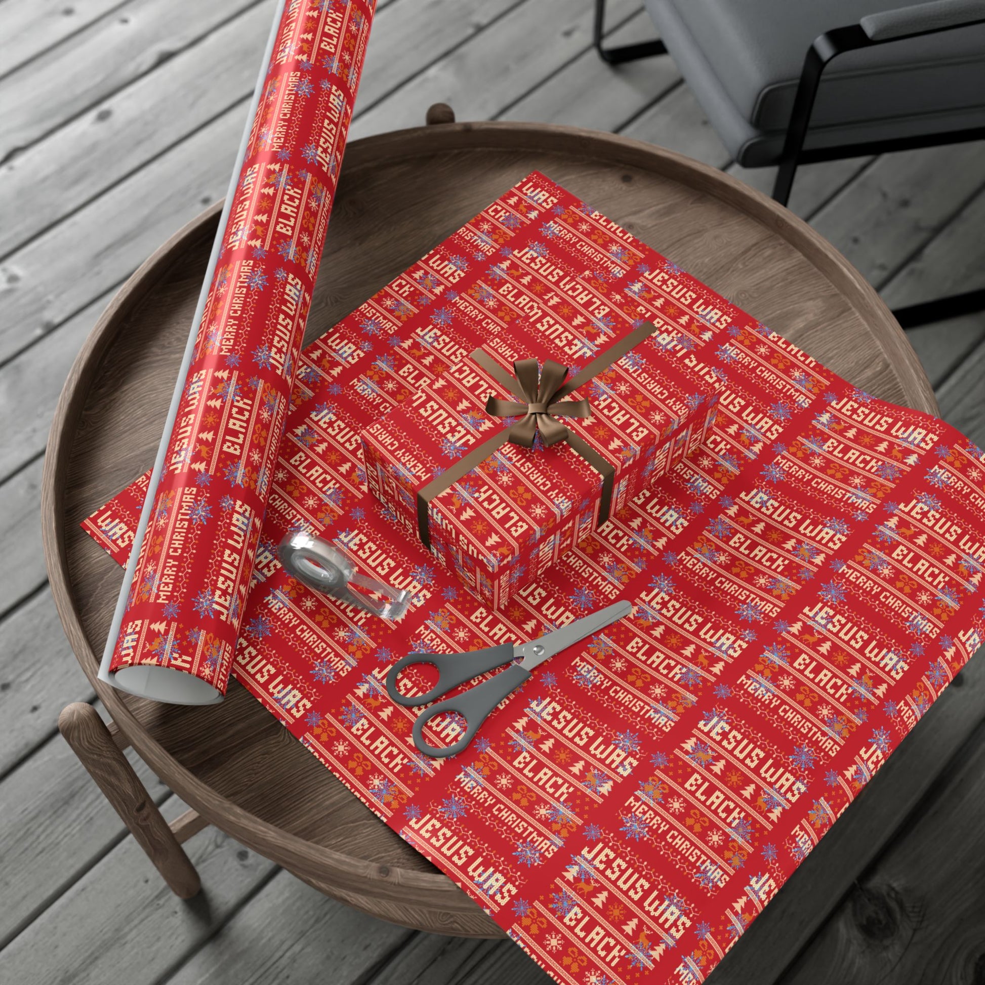 Red Jesus Was Black Merry Christmas wrapping paper roll and wrapped gifts on wooden table, perfect for statement holiday gift wrap.